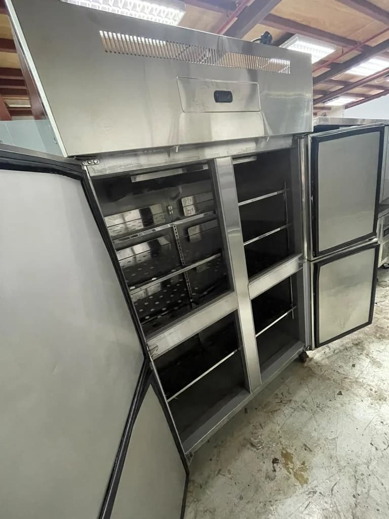 Interior view of 4-door commercial stainless steel upright chiller showing perforated shelves and rack slides Singapore